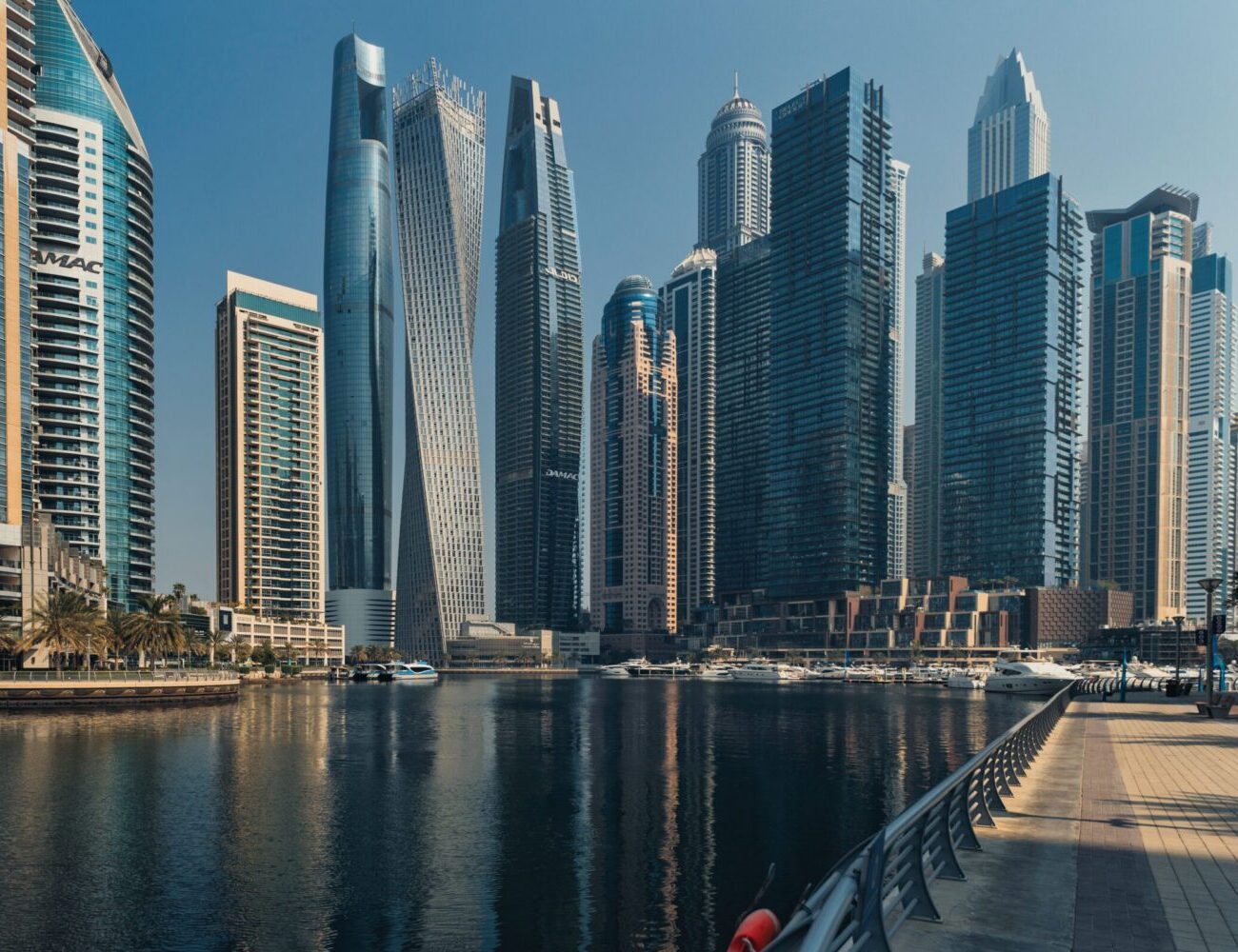 Explore the towering skyscrapers of Dubai Marina reflecting beautifully on the water.